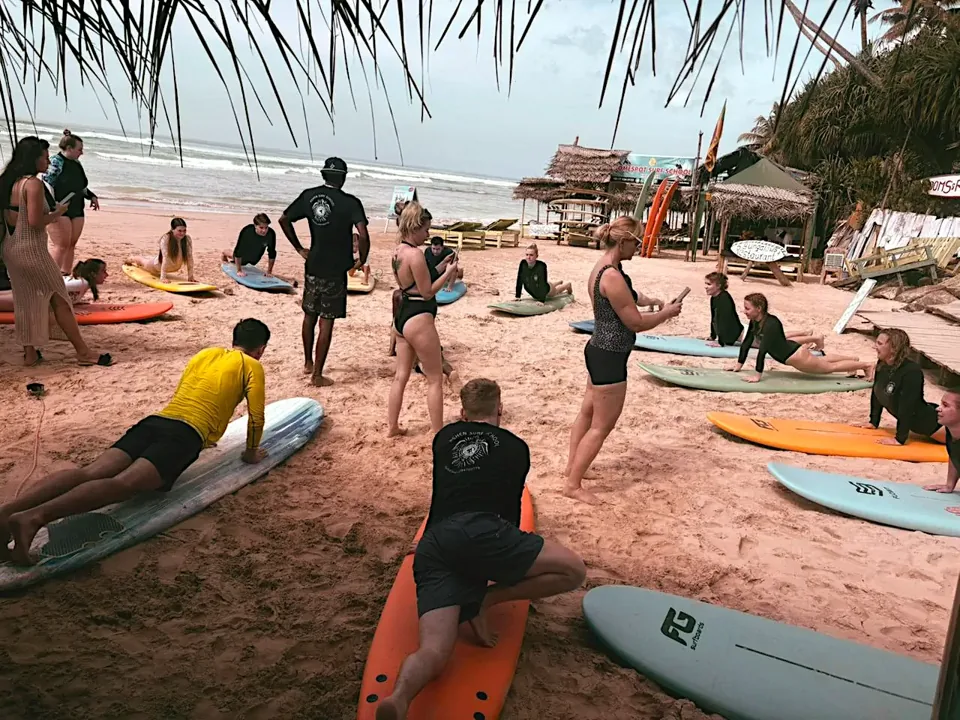 A group learns surfing together on Kabalana Beach